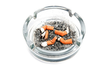 Glass ashtray with 5 cigarette buds isolated on white background