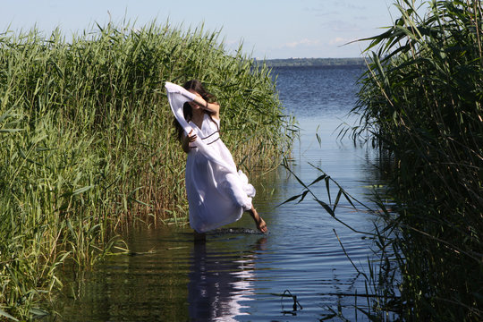 Young pregant girl at lake