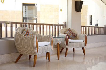 two armchairs end table in hall.