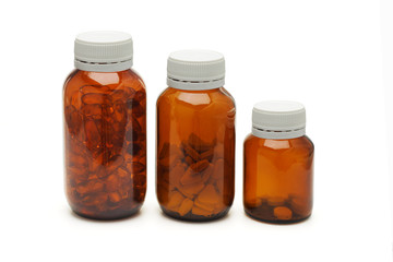 Three glass bottles of medicines on white background
