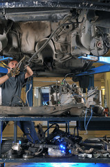 Auto mechanic working under the car - a series of MECHANIC