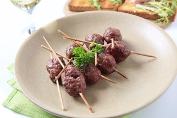 Roast meat balls on skewers