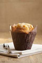 wrapped almond muffin in rustic style with pastry fork