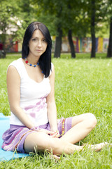 Naklejka na ściany i meble young serious woman rest in park