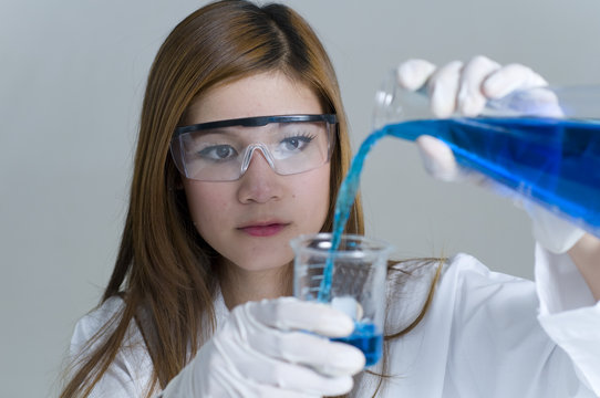 Student Researcher holding flask with chemicals in a laboratory