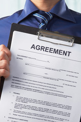 Businessman holding agreement paper