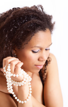 Portrait of a beautiful afro-american woman with pearl necklace