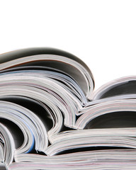 Stack of open magazines on white background
