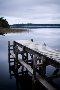 Wooden jetty on a calm lake in New Zealand
