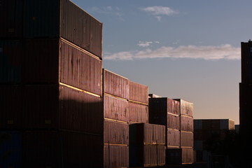 Cargo shipping containers stacked at port.