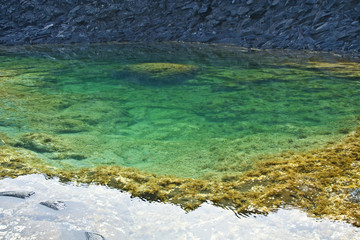 beautiful lake and stone structure at the coast line