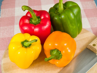 Bell Peppers on a Wooden Cutting Board with Knife