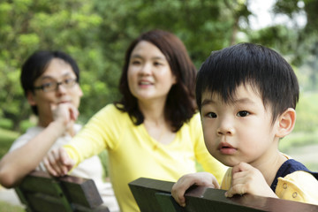 An Asian child with his parents