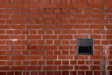 Fototapeta na wymiar Dirty brick wall with biult-in light housing