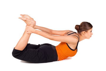 Fototapeta na wymiar Woman Practicing Yoga Exercise Called Bow Pose