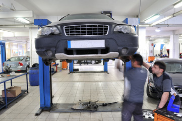 Auto mechanics working under the car - a series of MECHANIC