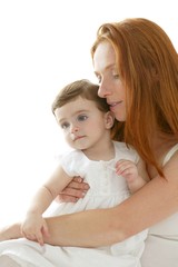 baby and redhead mother hug on white