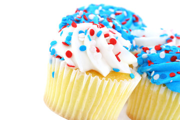 Festive cupcakes in red, white and blue on white background.