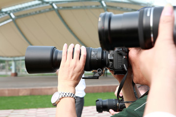 many photographers taking a photo with DSLR camera