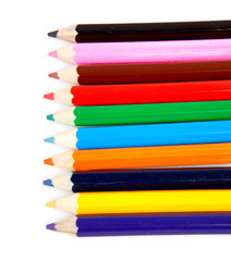 colorful pencils in a row over white background
