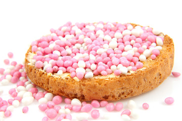 Rusk with pink and white mice over white background