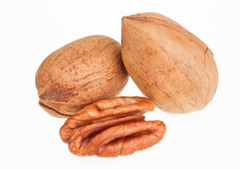 Few pecan nuts isolated on white, one cracked