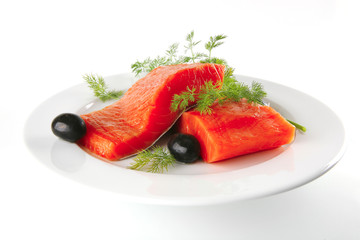fresh smoked salmon on white plate with olives