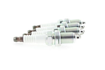 Four Spark Plugs on a white background