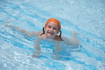 Fototapeta na wymiar little girl in pool. blue water