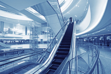 Moving up escalator in trade center .