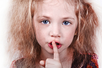 cute little girl with finger in lips