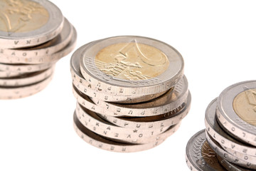 Three columns of coins with second one focused isolated on white