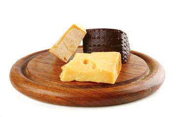 aged cheeses on round wooden board