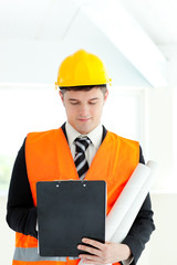 Serious male architect holding blueprints