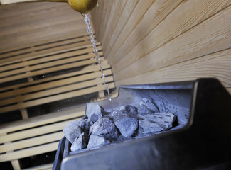 hot stones and splashing water in sauna