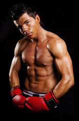 Fototapeta na wymiar muscular man fighting box over dark