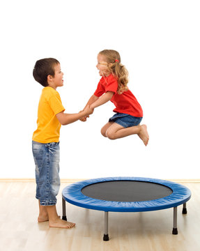 Kids having fun with a trampoline in the gym