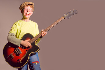 Obraz premium The boy with a guitar