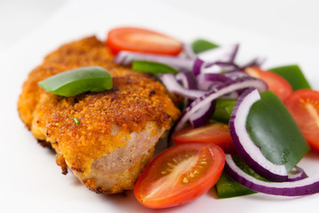 Breaded chicken breast with fresh vegetables