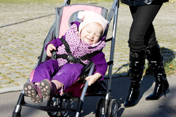 woman with toddler sitting in pram on walk