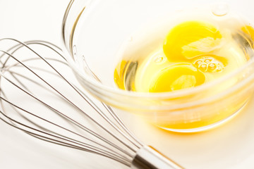 Hand Mixer with Eggs in Glass Bowl