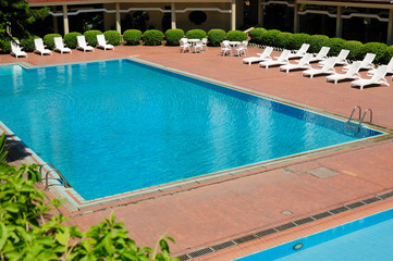 swimming pool and chaise longues