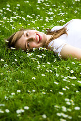 Young woman lying on the grass
