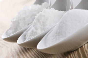 three spoons with different salt