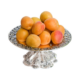 Apricots on a plate isolated on a white background.