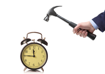A businessman's hand about to break an old clock