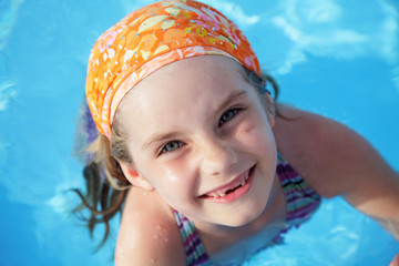 little girl in pool. blue water