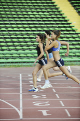 girls running on athletics race track