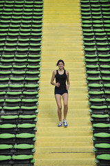 Fototapeta na wymiar woman jogging at athletics stadium