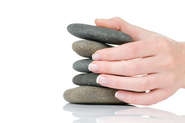 Female hands holding pile of stones isolated on white